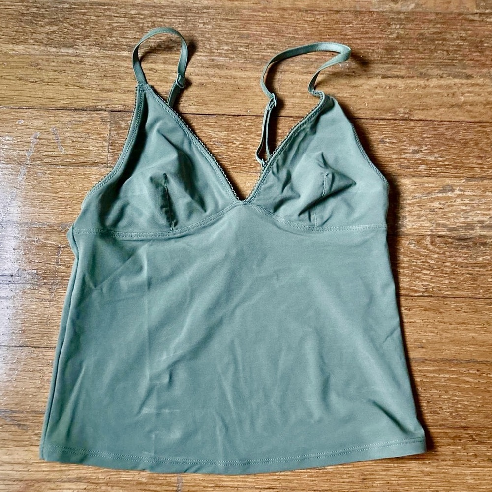 Out from under green tank top